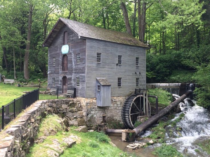 an old water mill in the woods near a stream