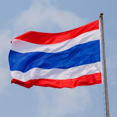 the flag of thailand is flying high in the blue sky with white and red stripes