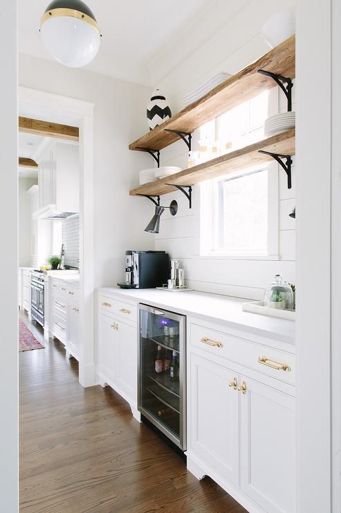 a kitchen with white cabinets and open shelves