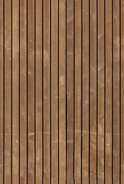 a brown wooden wall with vertical lines painted on the side and wood slats at the bottom