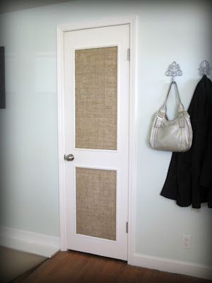 a white door with some burlap on it and a handbag hanging from the handle