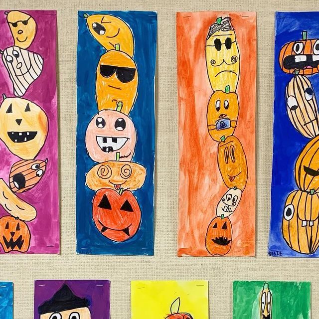 four colorful paper bags with cartoon faces and pumpkins on them, all painted in different colors