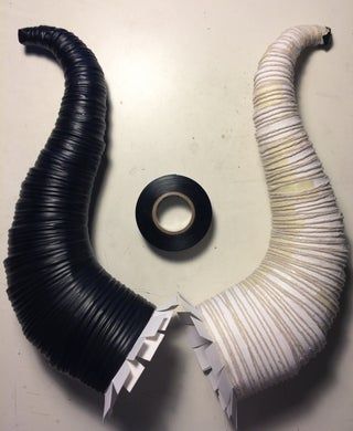 two pieces of black and white wire sitting on top of a table