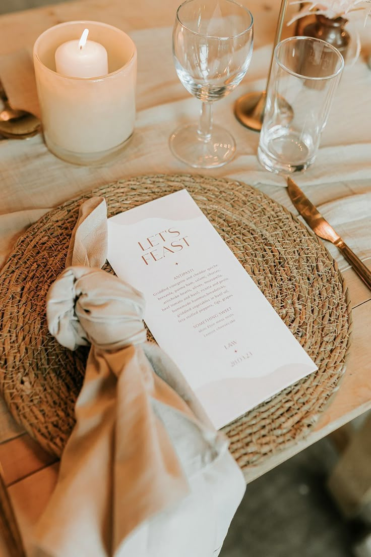 a place setting with napkins and candles