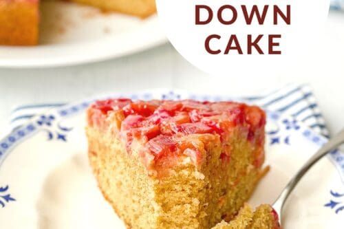 a slice of strawberry upside down cake on a plate with a fork next to it