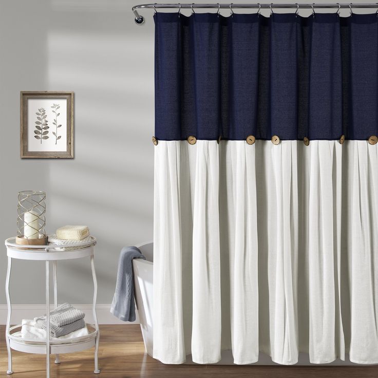 a bathroom with a blue and white shower curtain