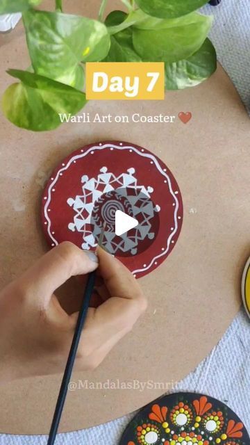 someone is painting a paper plate with flowers on it and the words, day 7 warli art on coasters