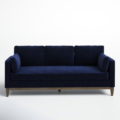 a blue couch sitting on top of a white floor