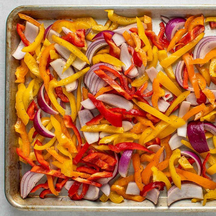 a pan filled with sliced up vegetables on top of a table