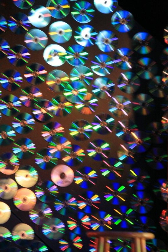 the ceiling is covered with many different colored cds