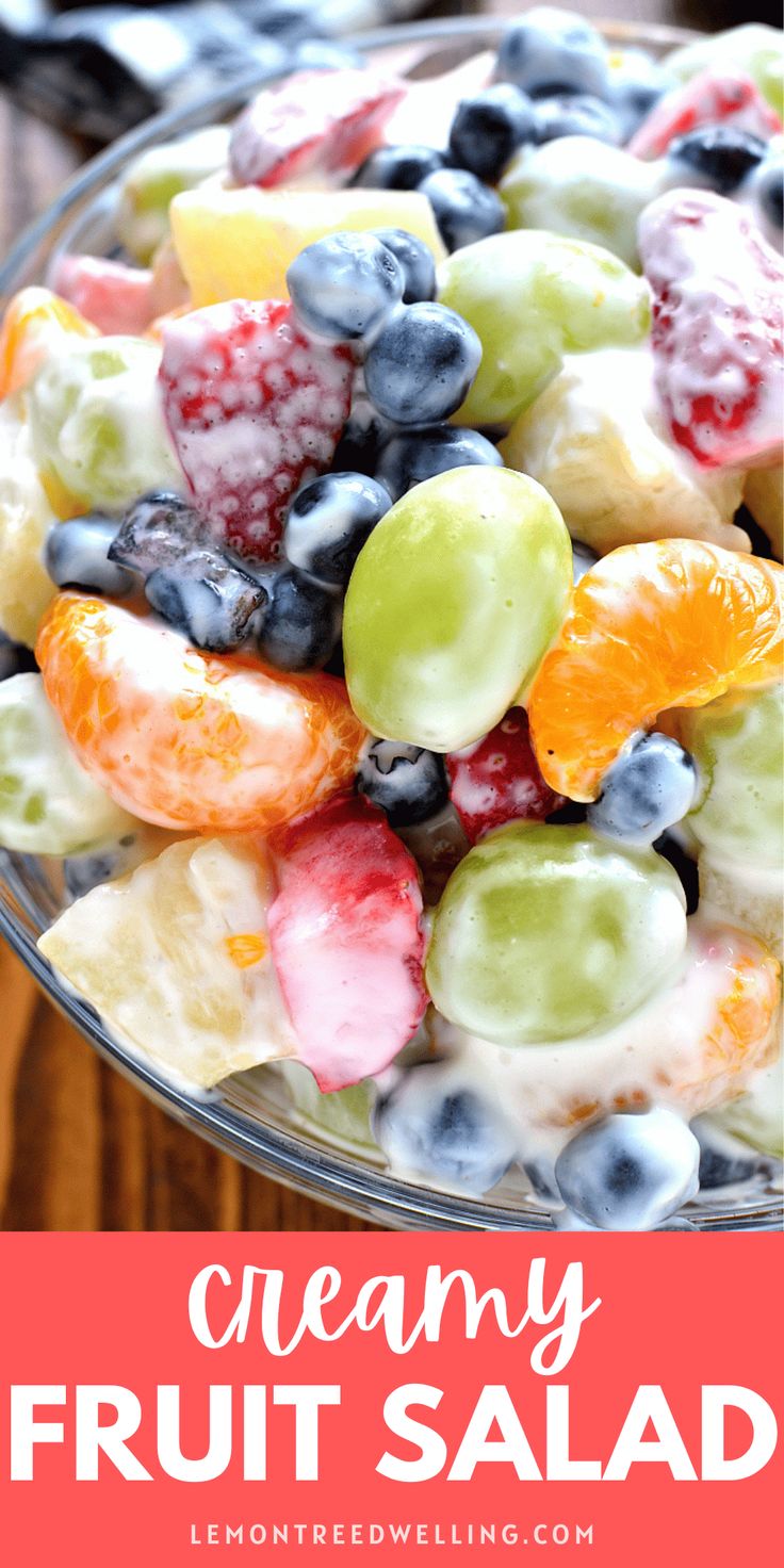 a bowl full of fruit salad with the words creamy fruit salad on top and below