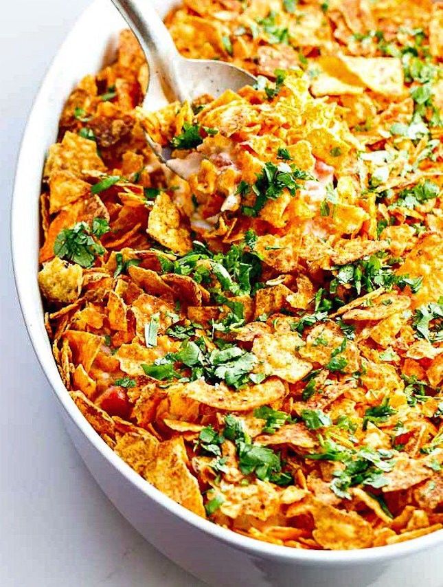 a white bowl filled with lots of food on top of a wooden spoon in front of an instagram page