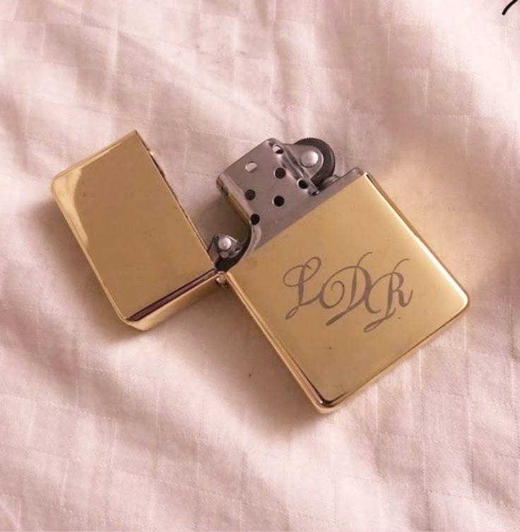 a lighter with the word dork written on it sitting on top of a white sheet