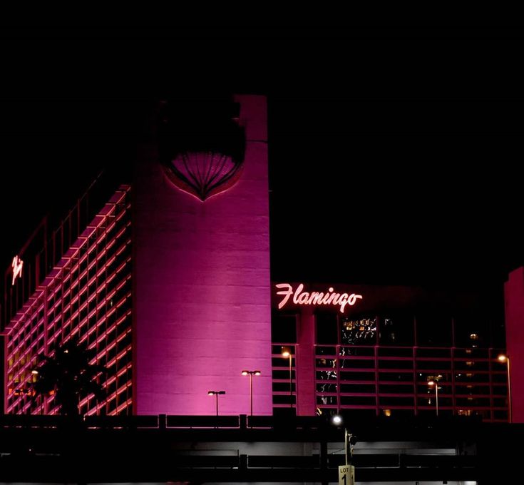 the flaming tower lit up at night in las vegas, nv with pink lighting