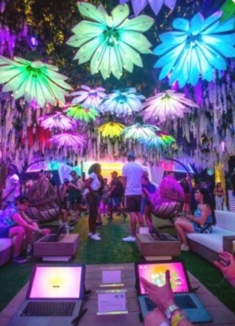 people sitting on couches with laptops in front of them at an outdoor event