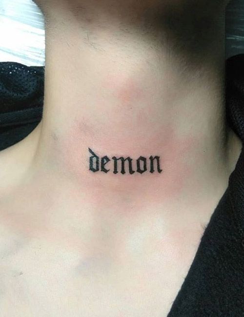 a woman with a tattoo on her neck that says demon written in cursive font