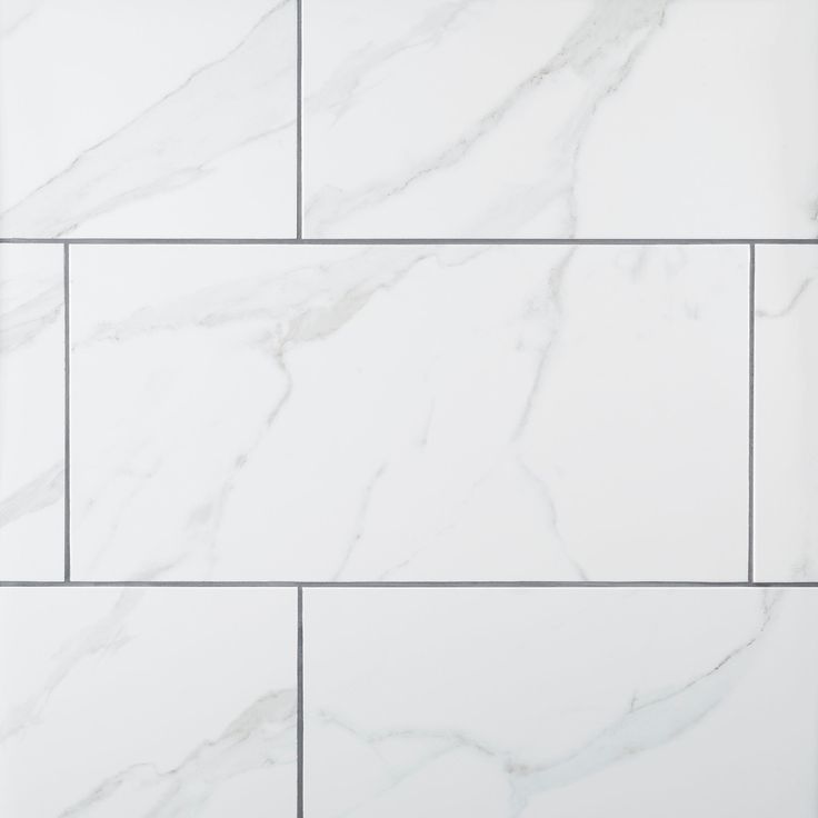 a white marble tile wall with grey lines