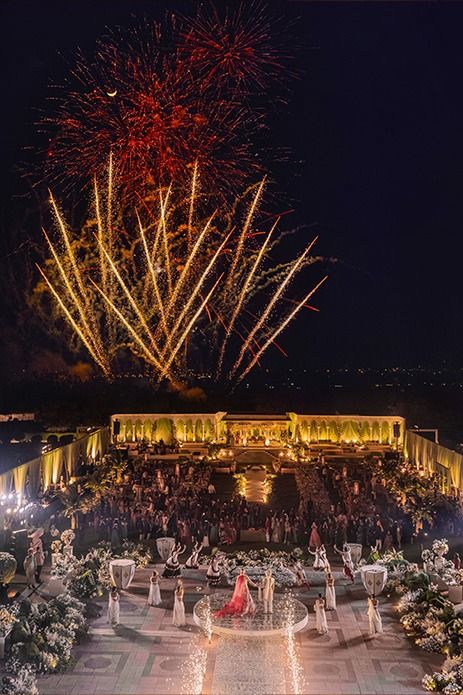 fireworks are lit up in the sky above a crowd