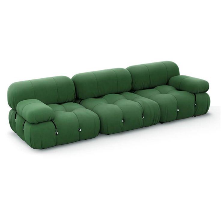 a green couch sitting on top of a white floor