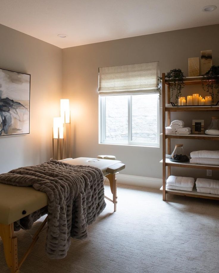 a spa room with towels and candles on the shelves