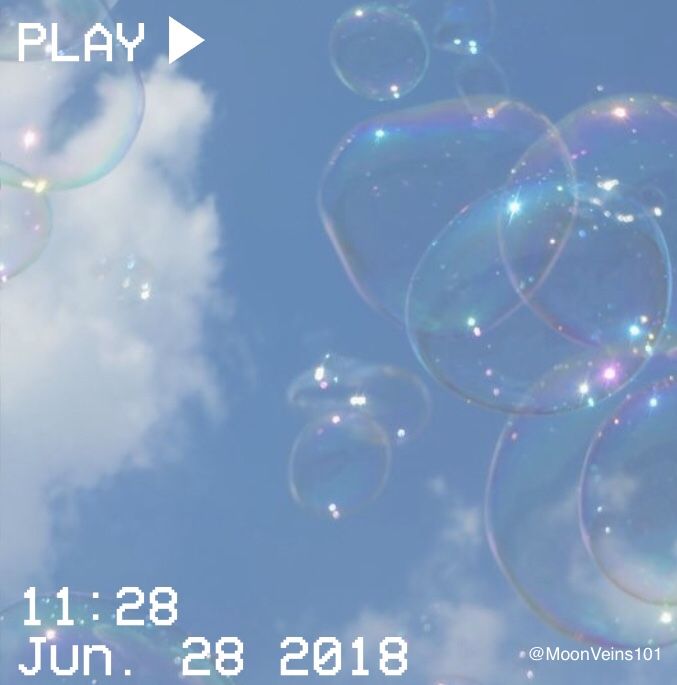 an image of soap bubbles floating in the sky