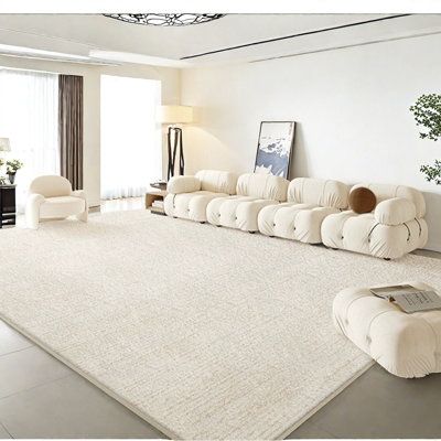 a living room filled with furniture and a white rug