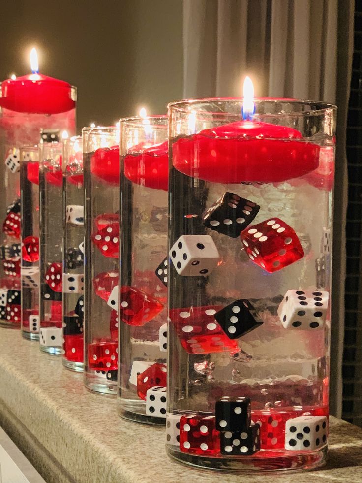 candles are lined up with dices in them