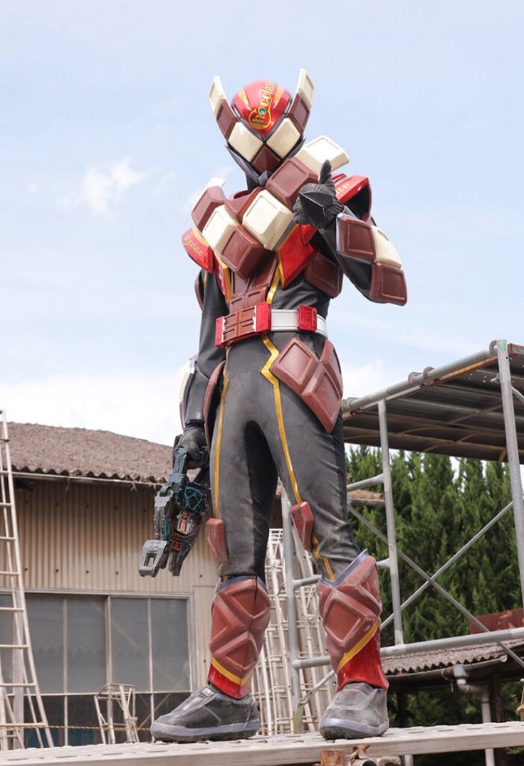 a man dressed in armor standing on top of a wooden platform next to a building