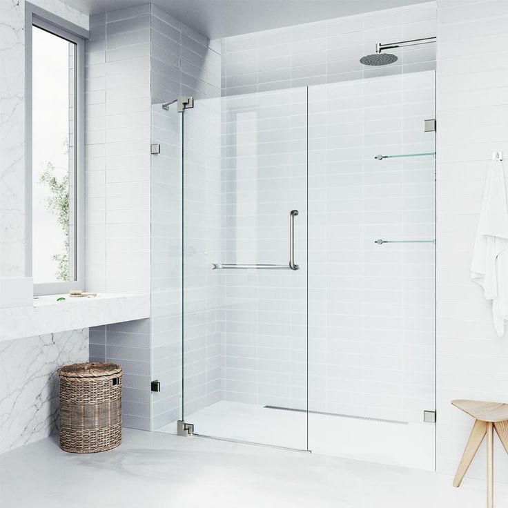 a bathroom with a walk in shower next to a white sink and mirror on the wall