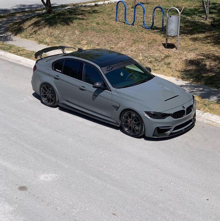 a silver car parked on the side of a road