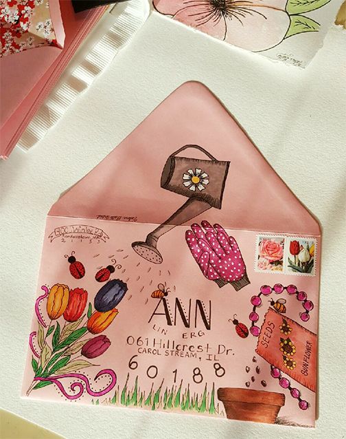 a pink envelope with an image of a woman's shoe and flowers on it