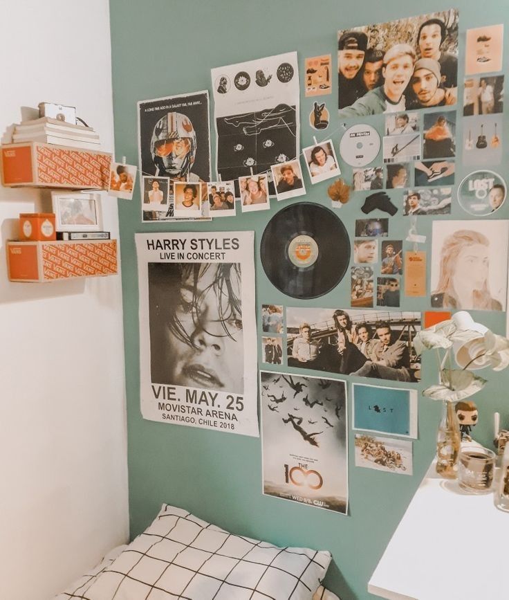 a bedroom with posters and pictures on the wall, including an old record player's head