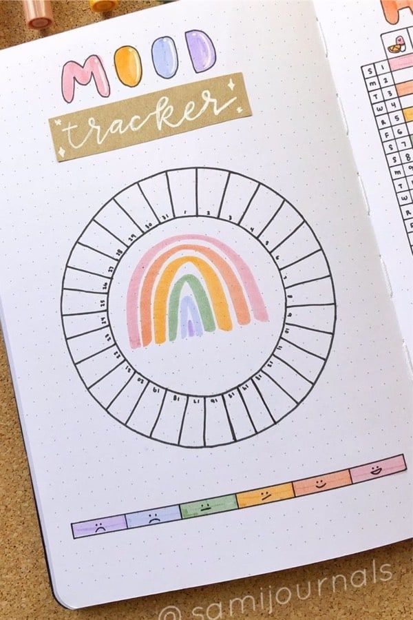 an open planner with rainbows and numbers on it