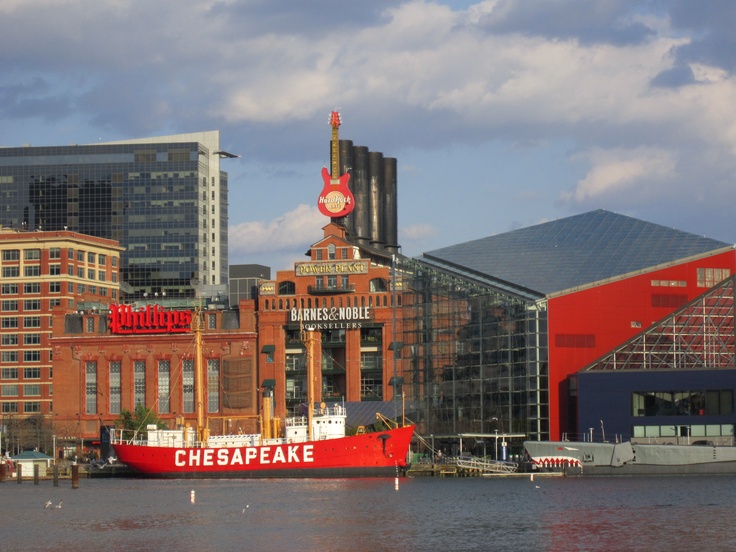 a large red boat in the water near some buildings