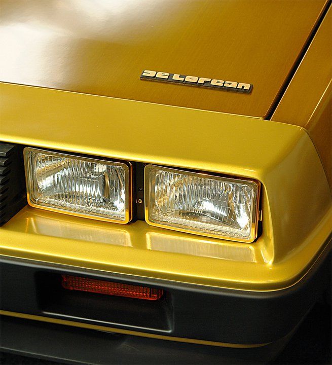 the front end of a yellow sports car