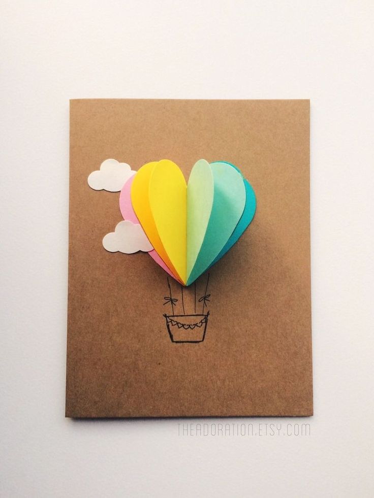 there is a card with a hot air balloon in the shape of a heart on it