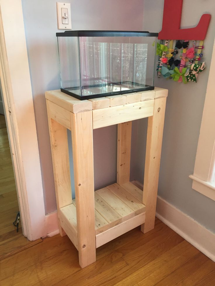 a fish tank sitting on top of a wooden table