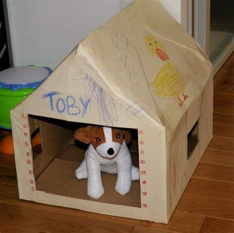 a toy dog in a cardboard box with writing on the side and inside it's door