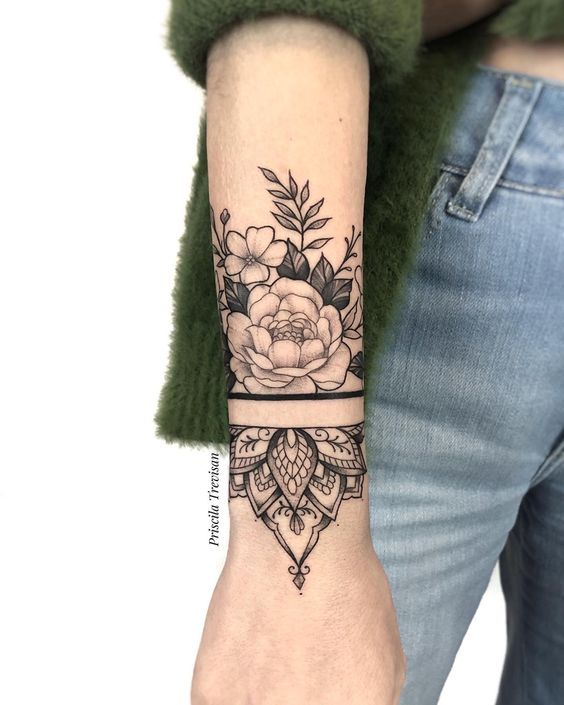 a woman's arm with a flower tattoo on it