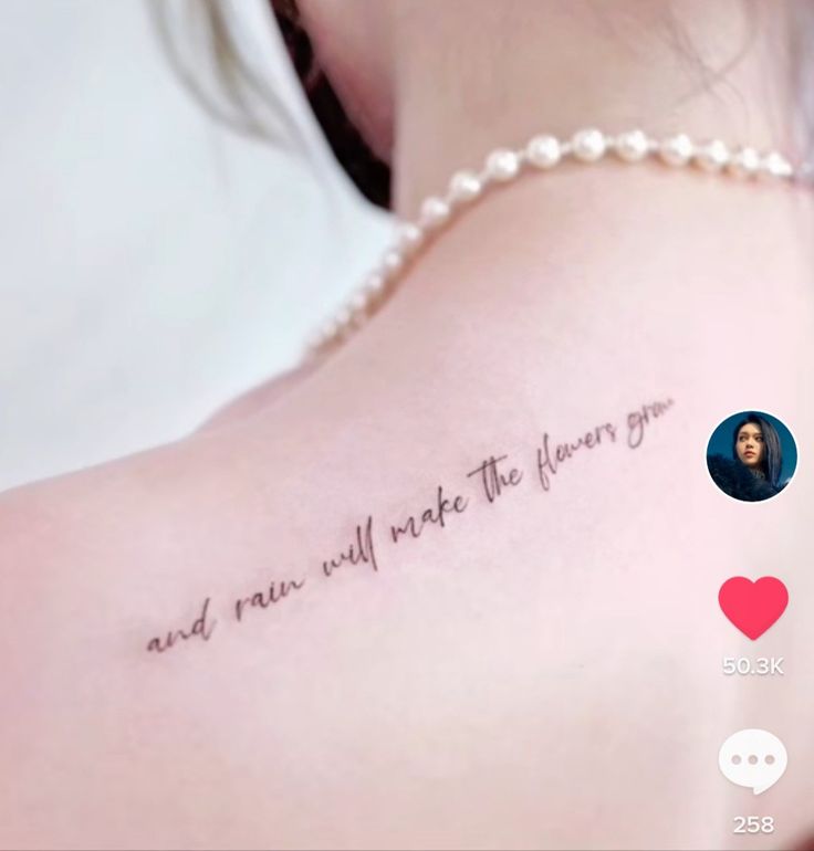 the back of a woman's shoulder with an inscription on it that says, and now we will make the flower grow