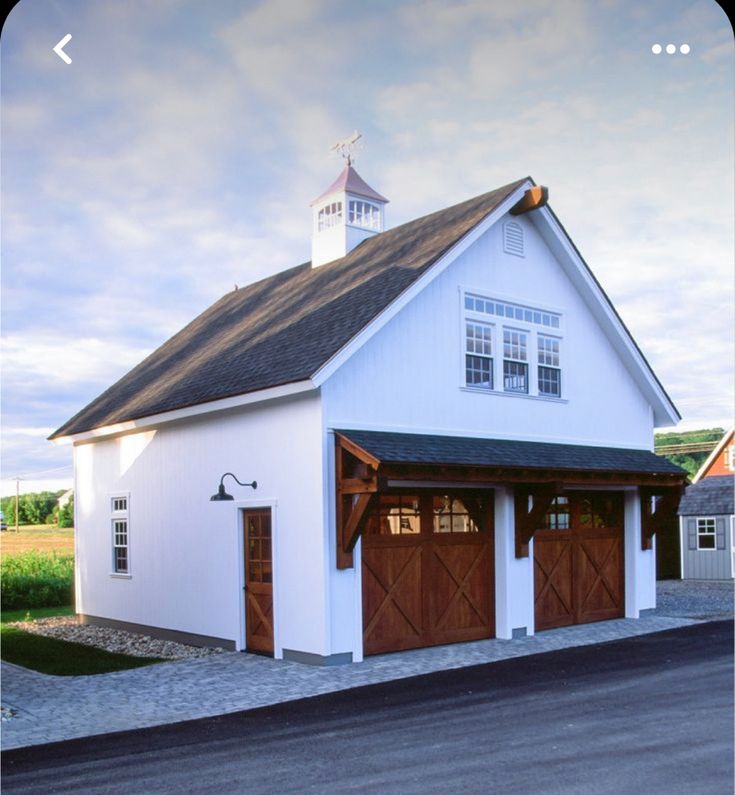 an image of a white house with two garages