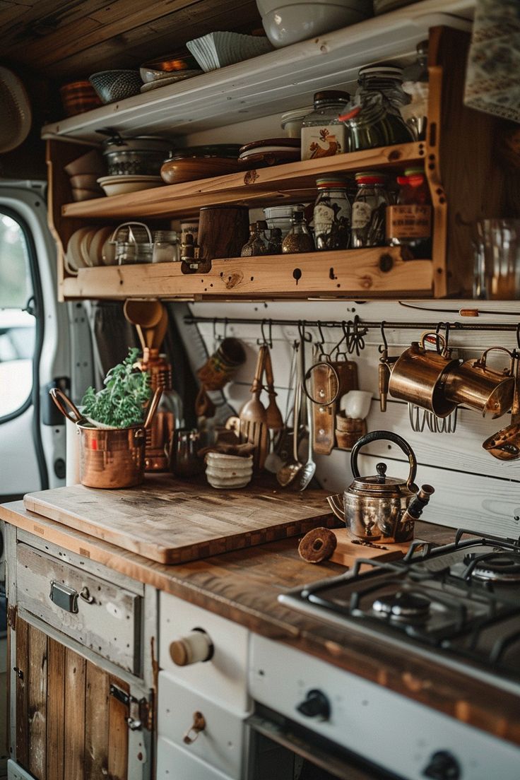 a kitchen with pots and pans hanging on the wall