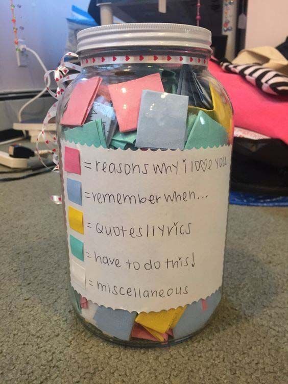 a jar filled with lots of papers on top of a table