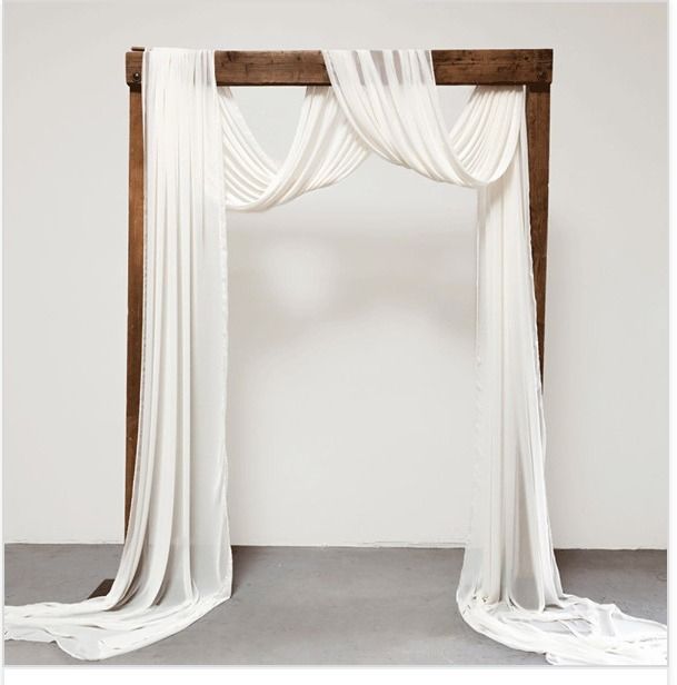 a white drape draped over a wooden frame