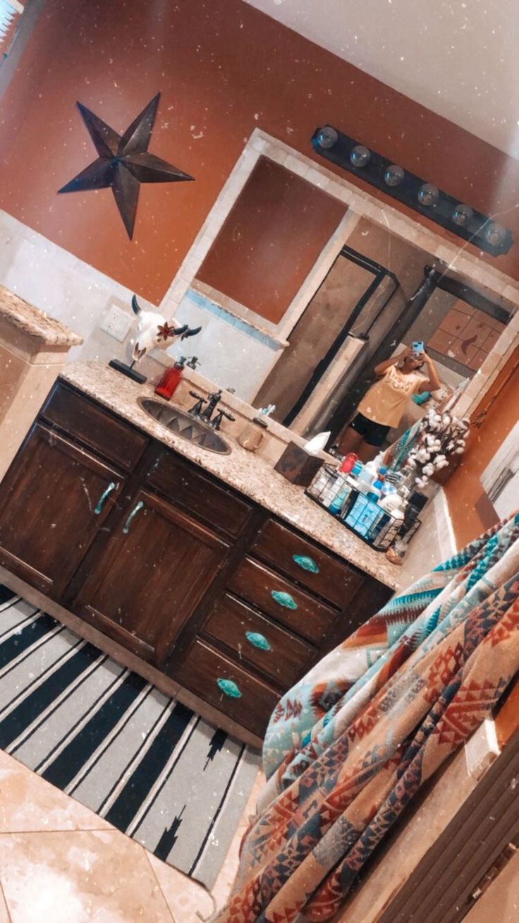 a bathroom with a star above the sink and tiled flooring in front of it