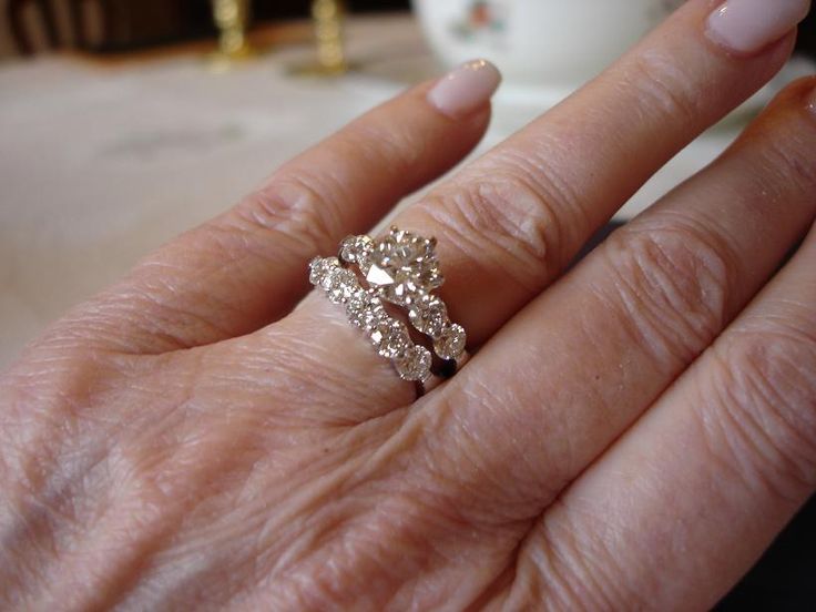 a close up of a person's hand with a ring on their finger,