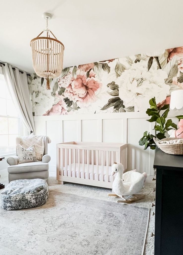 a baby's room with floral wallpaper and furniture