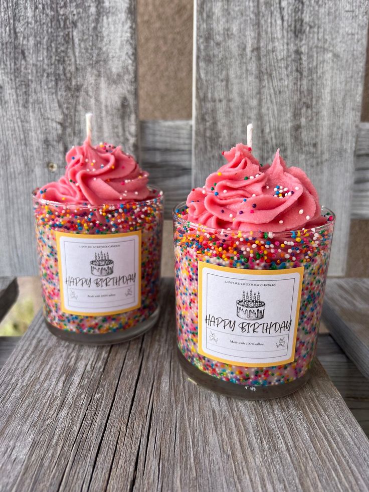 two candles with pink frosting and sprinkles