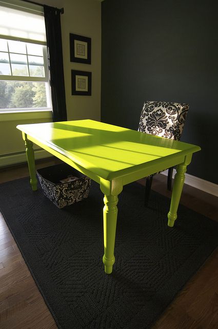 a bright green table in the corner of a room