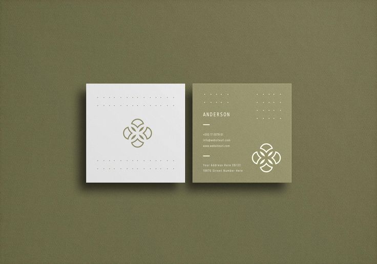 the business card is designed to look like it has an intricate design on it, and sits in front of a plain green background